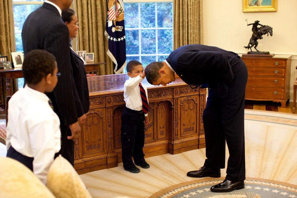 Little boy touching Barack Obama's Hair